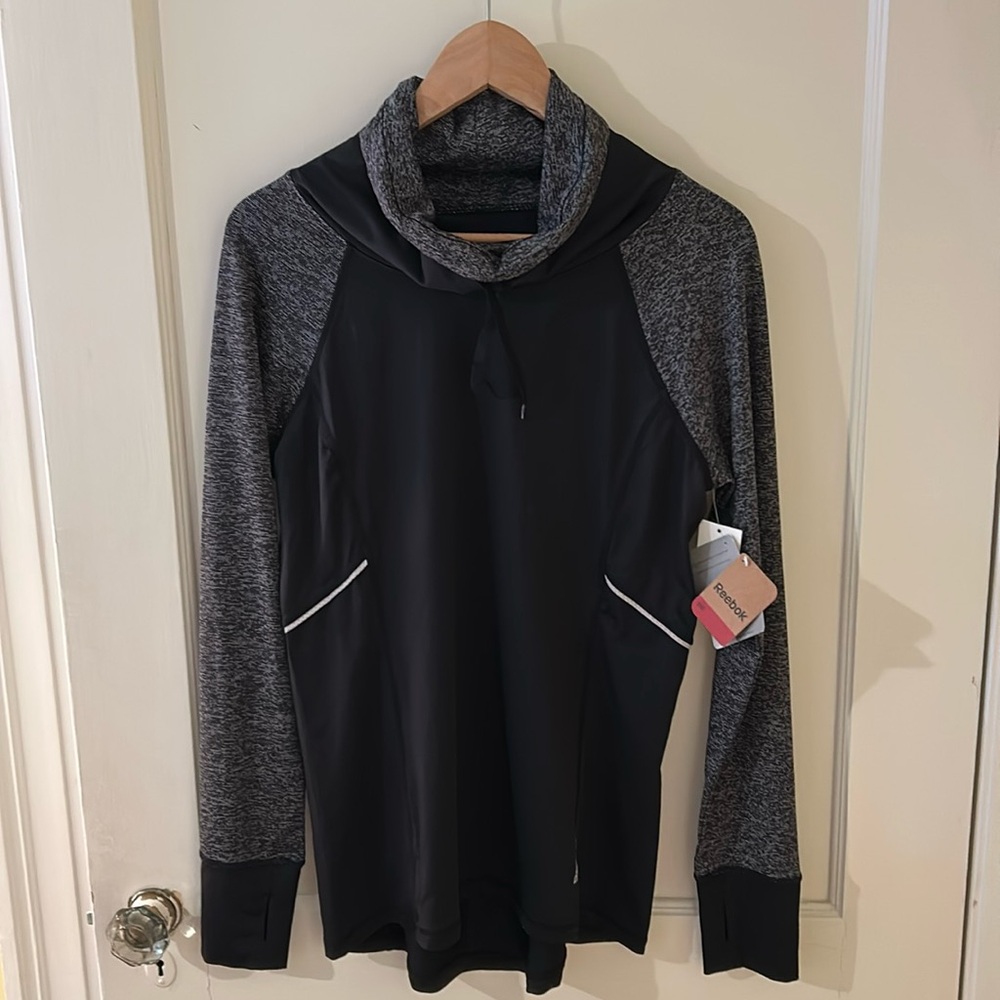 Reebok women’s athletic fit, long sleeve top.  Size M. New with tags.
